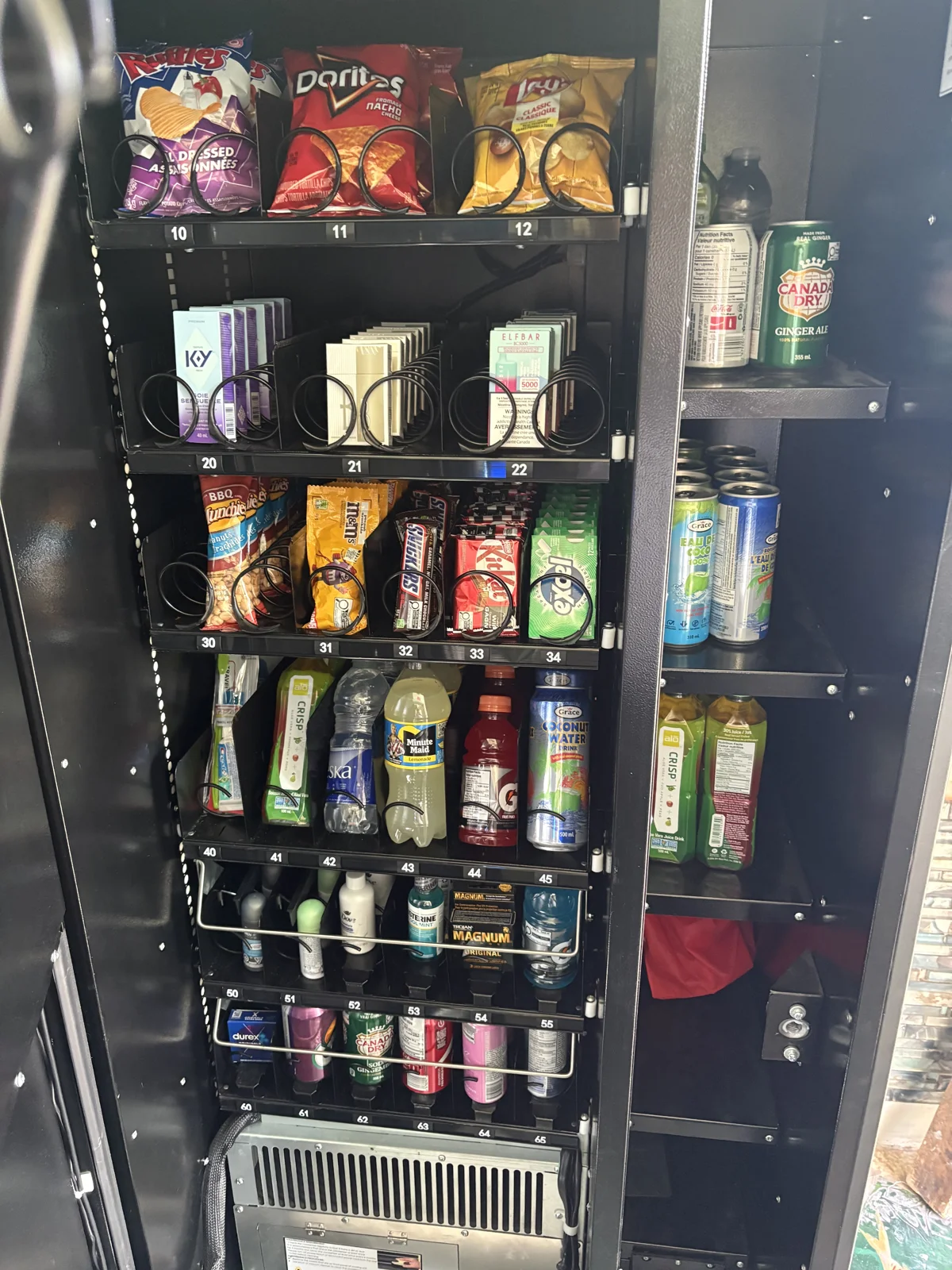 Traditional vending machine with visible product rows and familiar selection controls
