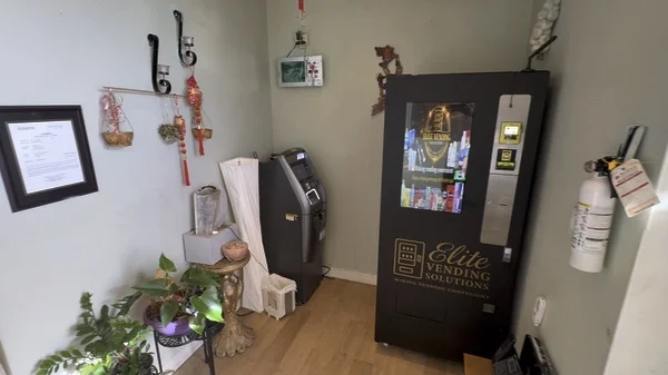 An Elite-branded vending machine at an indoor location